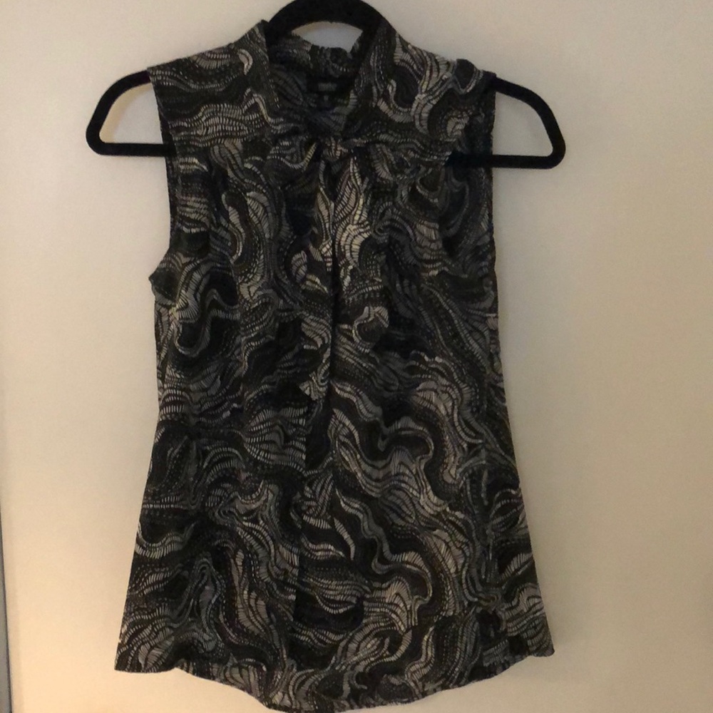 Black and white patterned sleeveless blouse.